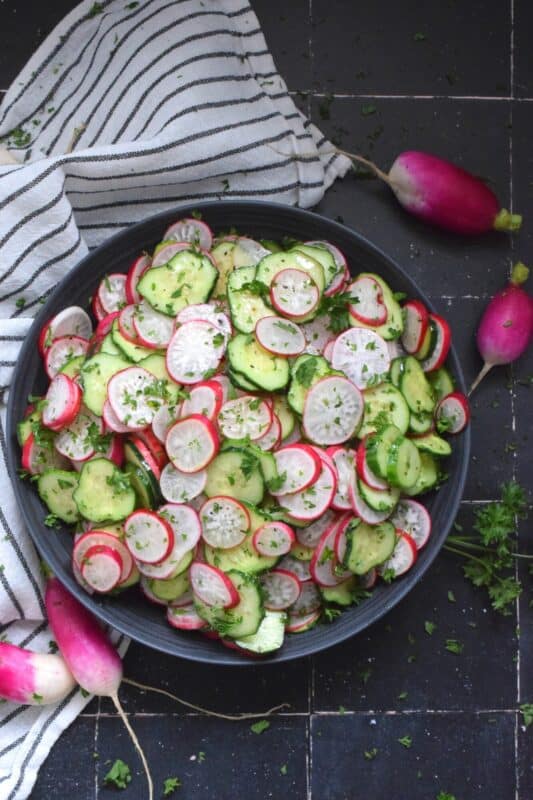 This light and refreshing salad is prepared with summer fresh cucumbers and radishes. Tossed in a quick and easy, seasoned homemade oil and vinegar dressing, this Radish and Cucumber Salad is loaded with crunch and texture. Can be prepared a day or two in advance as well!