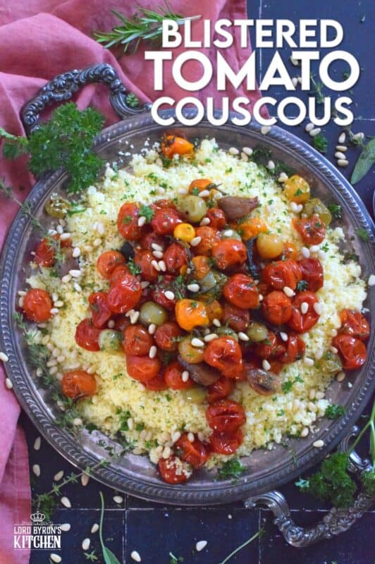 Summer fresh cherry tomatoes are slowly roasted with garlic, onions, and herbs in olive oil until the skins have blistered. Spoon over cooked couscous and sprinkle with pinenuts for a delicous, comforting, and filling main or side! #couscous #confit #tomato #roasted