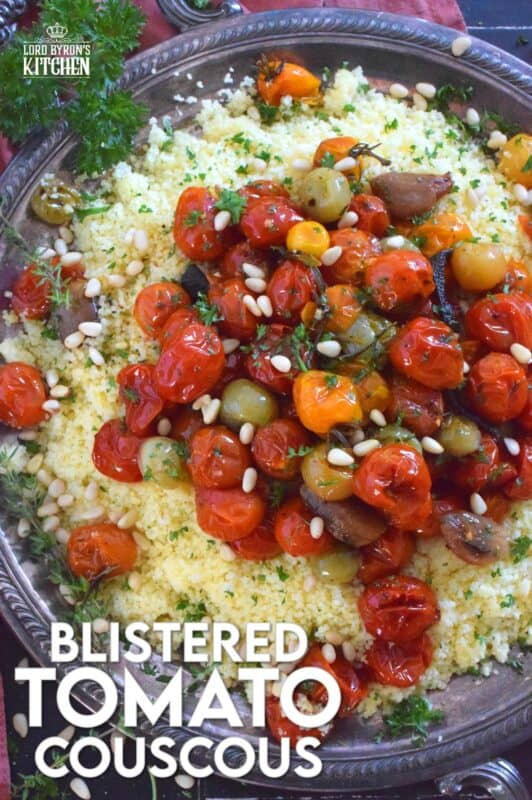 Summer fresh cherry tomatoes are slowly roasted with garlic, onions, and herbs in olive oil until the skins have blistered. Spoon over cooked couscous and sprinkle with pinenuts for a delicous, comforting, and filling main or side! #couscous #confit #tomato #roasted