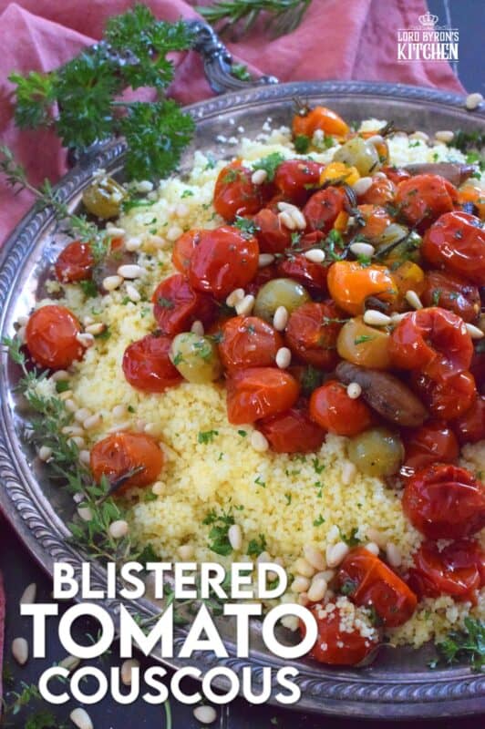 Summer fresh cherry tomatoes are slowly roasted with garlic, onions, and herbs in olive oil until the skins have blistered. Spoon over cooked couscous and sprinkle with pinenuts for a delicous, comforting, and filling main or side! #couscous #confit #tomato #roasted