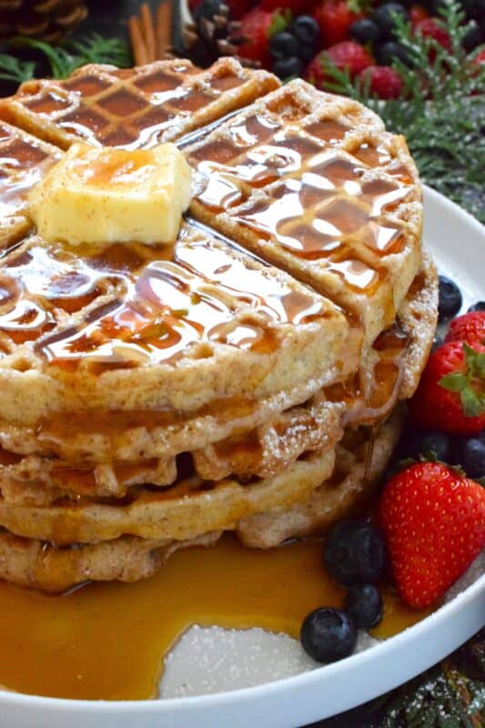If Christmas had a flavour, it would be gingerbread, so let's start the day off right with these light and airy Buttermilk Gingerbread Waffles! These super easy-to-prepare homemade waffles are piled high and generously dressed with warm syrup and a pat of butter. #waffles #gingerbread #christmas #breakfast