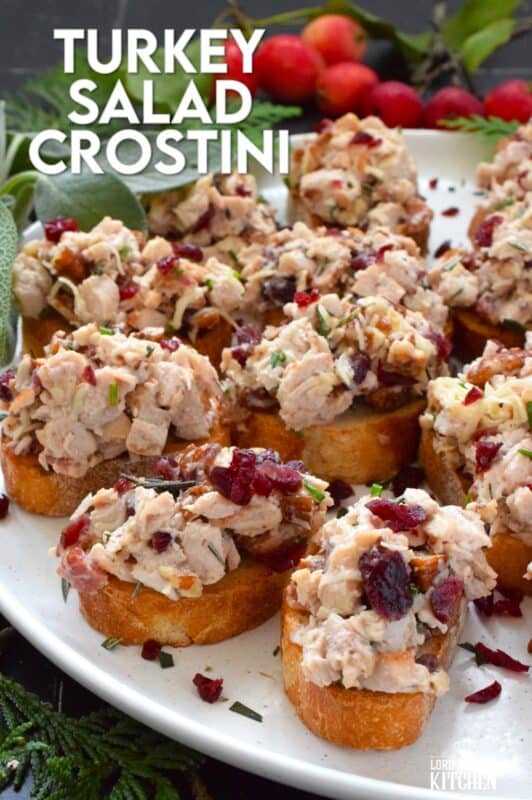 Chopped turkey breast meat is combined with bacon, cheese, and cranberries and piled onto lightly toasted or grilled bread. These crostini are savoury and sweet and have the makings of a great Christmas dinner in appetizer form. Alternatively, serve the turkey salad with crackers as a dip! #turkey #cranberry #crostini #appetizer #bacon
