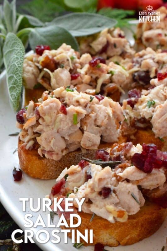 Chopped turkey breast meat is combined with bacon, cheese, and cranberries and piled onto lightly toasted or grilled bread. These crostini are savoury and sweet and have the makings of a great Christmas dinner in appetizer form. Alternatively, serve the turkey salad with crackers as a dip! #turkey #cranberry #crostini #appetizer #bacon