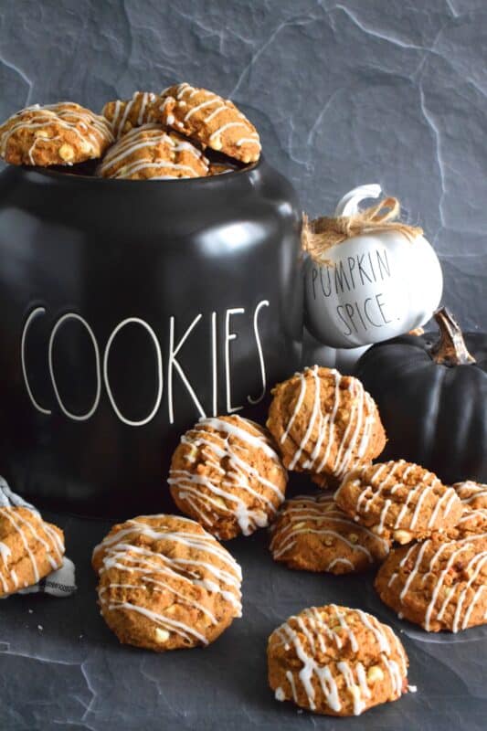 Pecan Pumpkin Cookies are prepared with molasses, real pumpkin puree, lots of pumpkin spice flavour, white chocolate chips, and chopped pecans. Topped with a sweet glaze, they are delectably moist and flavourful. If you're looking for a cookie that tastes like fall, look no further! #pumpkin #pecan #spice #puree #cookies