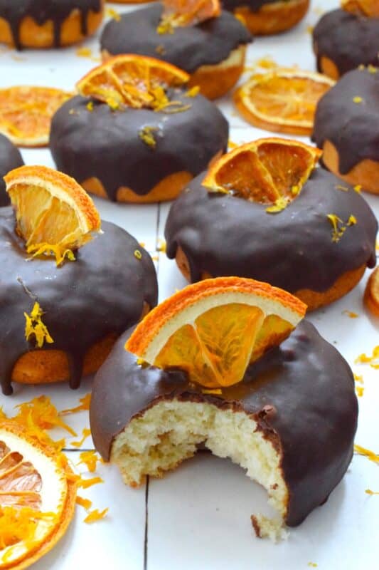 The combination of chocolate and orange is often found in holiday baking, and oranges have quite a history when it comes to being a staple in most Christmas traditions. Candied Orange Donuts is the dessert you didn't know you needed this Christmas! #candied #orange #donut #doughnut