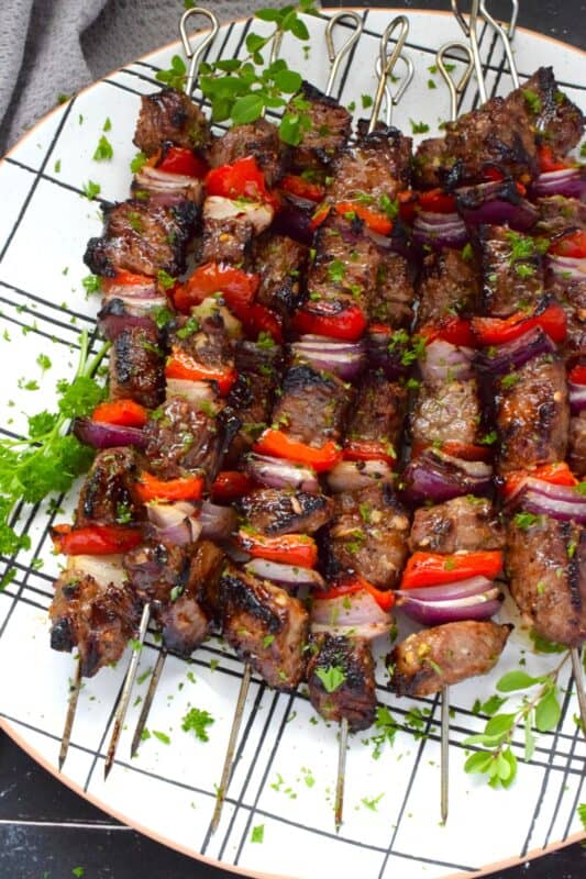 Marinated and skewered, Grilled Garlic Beef is simple and easy to prepare, but the flavour is extraordinary! The quick-to-prepare marinade is loaded with garlic which both permeates the beef and tenderizes it too. The addition of the onions and sweet bell peppers round out the flavour. #beef #garlic #garlicky #grill #bbq