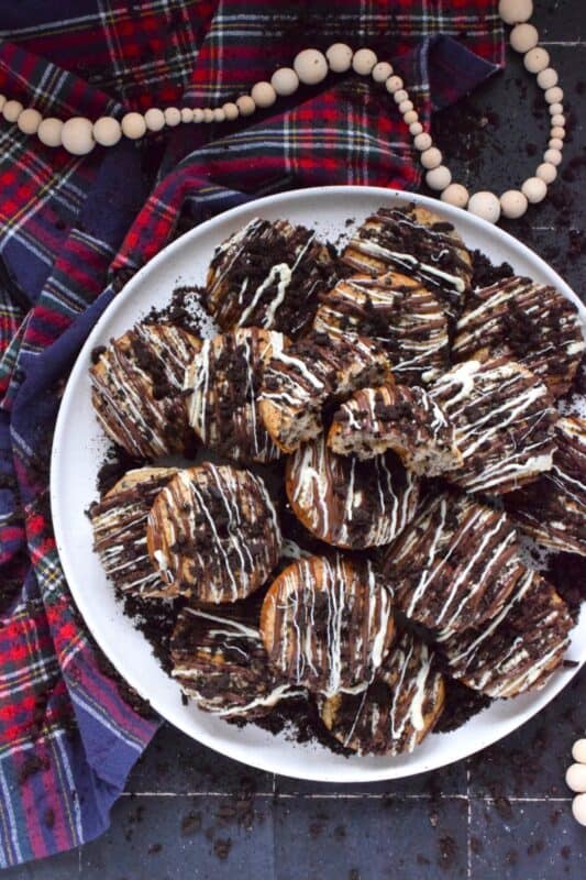 Crushed Oreo cookies are packed into the most delicious vanilla cake donuts and topped with smooth, melted white and milk chocolate, and even more crushed Oreos! Don't worry about the indulgence of these donuts because they're baked and not fried which means you're saving on calories! Right!? #cookiesandcream #oreo #donuts