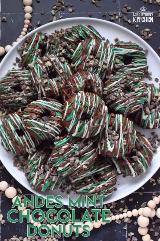These donuts are loaded with mint flavour and are meant for serious mint and chocolate lovers. Andes Mint Chocolate Donuts are baked with good cocoa, mint extract, and mint chocolate, and topped with green candy melts and melted white and milk chocolate. It was so hard to eat just one of these! #andesmints #chocolates #donuts