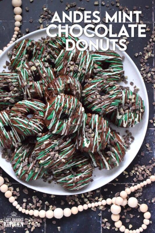 These donuts are loaded with mint flavour and are meant for serious mint and chocolate lovers. Andes Mint Chocolate Donuts are baked with good cocoa, mint extract, and mint chocolate, and topped with green candy melts and melted white and milk chocolate. It was so hard to eat just one of these! #andesmints #chocolates #donuts