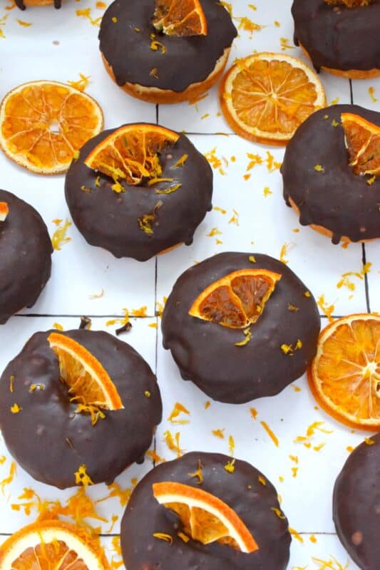 The combination of chocolate and orange is often found in holiday baking, and oranges have quite a history when it comes to being a staple in most Christmas traditions. Candied Orange Donuts is the dessert you didn't know you needed this Christmas! #candied #orange #donut #doughnut