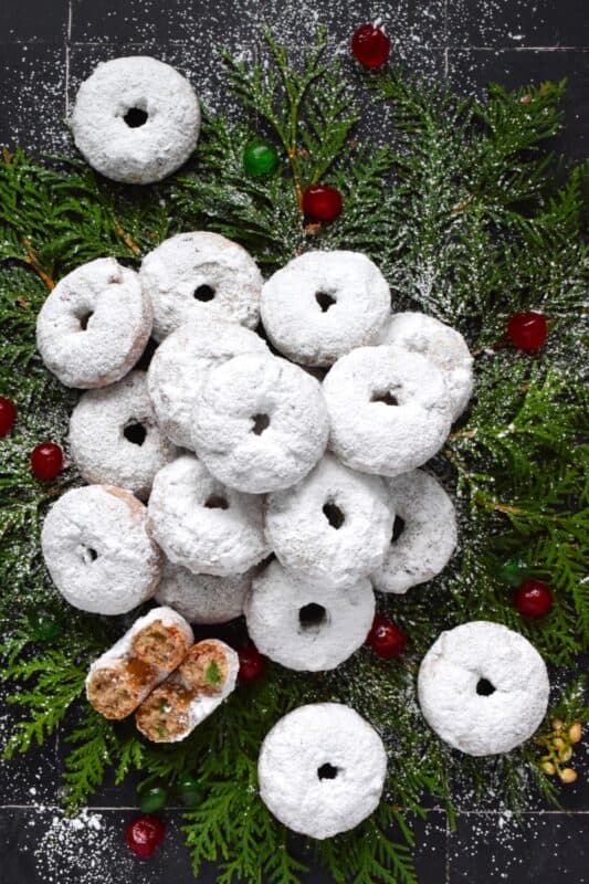 Packed full of red and green candied cherries and chopped toasted walnuts, these Walnut Cherry Donuts are the epitome of holiday-themed donuts! Baked with familiar Christmas spices, this donut is very similar in flavour to fruitcake - but without the fuss! #walnut #candied #cherries #donuts