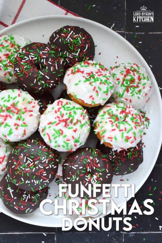 For the kid in all of us this holiday season let's make some Funfetti Christmas Donuts! This light and fluffy vanilla donut is filled with sprinkles and topped with a sugary, sweet glaze. Better than store-bought, these donuts make a lovely bring-along party treat as well! #funfetti #sprinkles #christmas #donuts #doughnuts