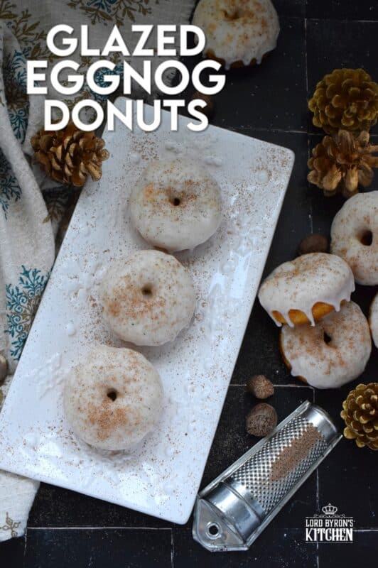 These Glazed Eggnog Donuts are baked and not fried, which means they are super light and fluffy. Eggnog is baked right into the batter and the glaze is made with eggnog too, ensuring that this donut lives up to its name! Optionally, this recipe permits a splash or rum or an alcohol-free version too! #donuts #doughnuts #eggnog #christmas #baked