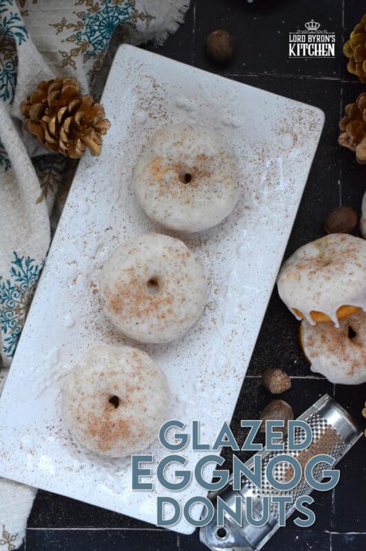 These Glazed Eggnog Donuts are baked and not fried, which means they are super light and fluffy. Eggnog is baked right into the batter and the glaze is made with eggnog too, ensuring that this donut lives up to its name! Optionally, this recipe permits a splash or rum or an alcohol-free version too! #donuts #doughnuts #eggnog #christmas #baked