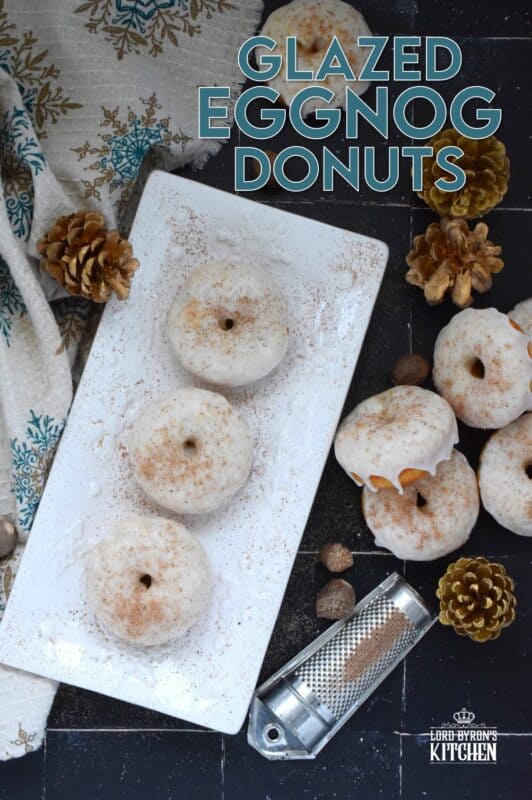 These Glazed Eggnog Donuts are baked and not fried, which means they are super light and fluffy. Eggnog is baked right into the batter and the glaze is made with eggnog too, ensuring that this donut lives up to its name! Optionally, this recipe permits a splash or rum or an alcohol-free version too! #donuts #doughnuts #eggnog #christmas #baked