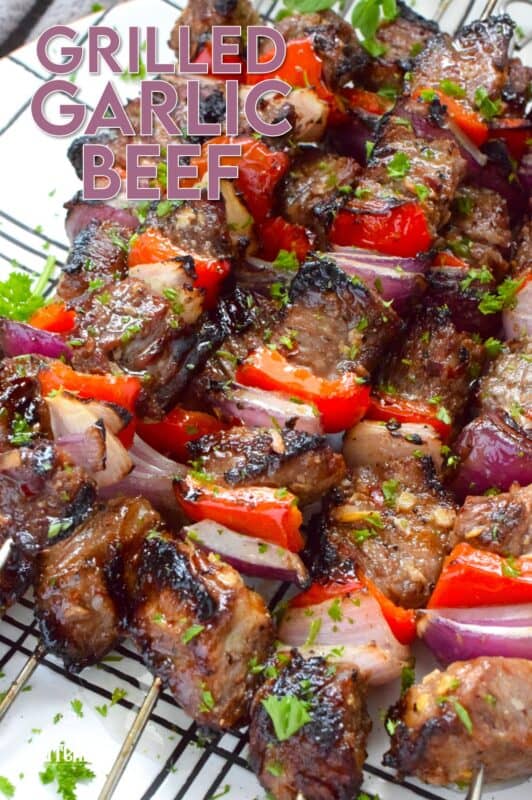 Marinated and skewered, Grilled Garlic Beef is simple and easy to prepare, but the flavour is extraordinary! The quick-to-prepare marinade is loaded with garlic which both permeates the beef and tenderizes it too. The addition of the onions and sweet bell peppers round out the flavour. #beef #garlic #garlicky #grill #bbq