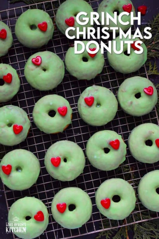 Grinch-themed confections are very popular at Christmastime, especially with kids! But even the adults will love these Grinch Christmas Donuts! Prepared with a baked basic donut recipe, these are dipped in green icing and despite the fact that the Grinch’s heart was three sizes too small, I’ve used the biggest red candy heart I could find! #ginch #donuts