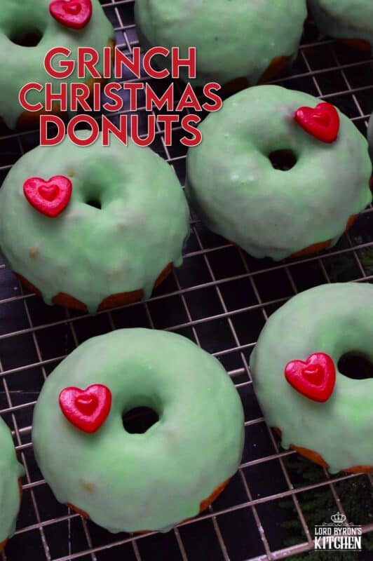 Grinch-themed confections are very popular at Christmastime, especially with kids! But even the adults will love these Grinch Christmas Donuts! Prepared with a baked basic donut recipe, these are dipped in green icing and despite the fact that the Grinch’s heart was three sizes too small, I’ve used the biggest red candy heart I could find! #ginch #donuts