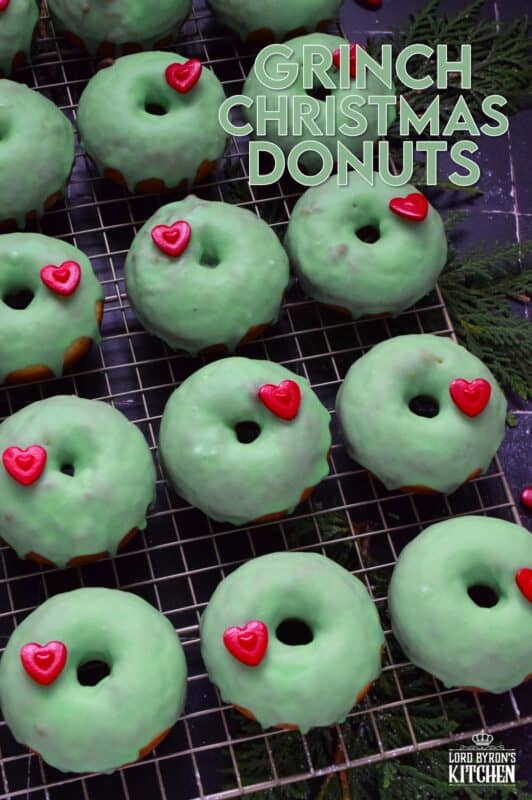 Grinch-themed confections are very popular at Christmastime, especially with kids! But even the adults will love these Grinch Christmas Donuts! Prepared with a baked basic donut recipe, these are dipped in green icing and despite the fact that the Grinch’s heart was three sizes too small, I’ve used the biggest red candy heart I could find! #ginch #donuts