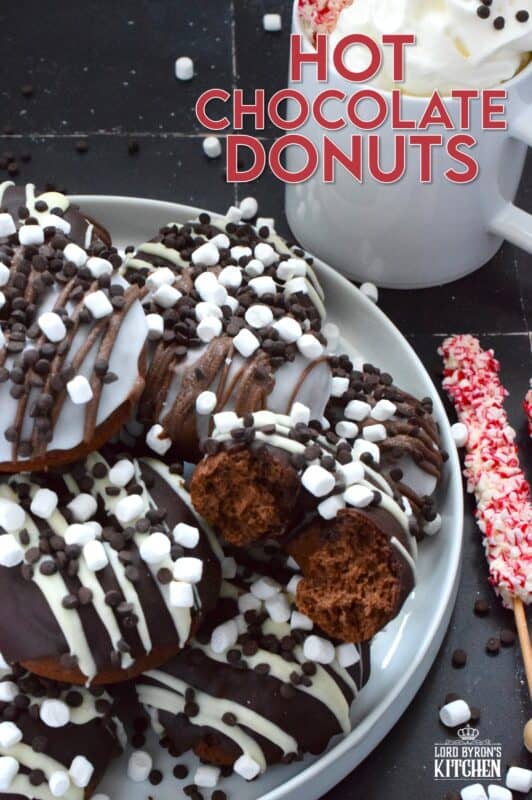 Good cocoa is the secret to a decadent hot chocolate; the same can be said for these Hot Chocolate Donuts.  Marshmallows are baked into the chocolate donut and sprinkled on top of the white glaze and the chocolate drizzle.  These baked donuts are for the ultimate chocolate lover! #hotchocolate #donuts #marshmallows