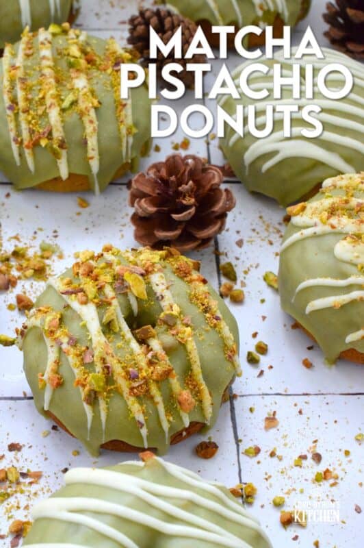 Everything is coming up green in these Matcha Pistachio Donuts! The batter is light and fluffy and prepared with finely chopped pistachios and matcha. Dipped in matcha-infused icing and drizzled with white chocolate, these donuts are delicious and addictive! #matcha #greentea #donuts #pistachio