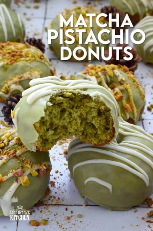 Everything is coming up green in these Matcha Pistachio Donuts! The batter is light and fluffy and prepared with finely chopped pistachios and matcha. Dipped in matcha-infused icing and drizzled with white chocolate, these donuts are delicious and addictive! #matcha #greentea #donuts #pistachio