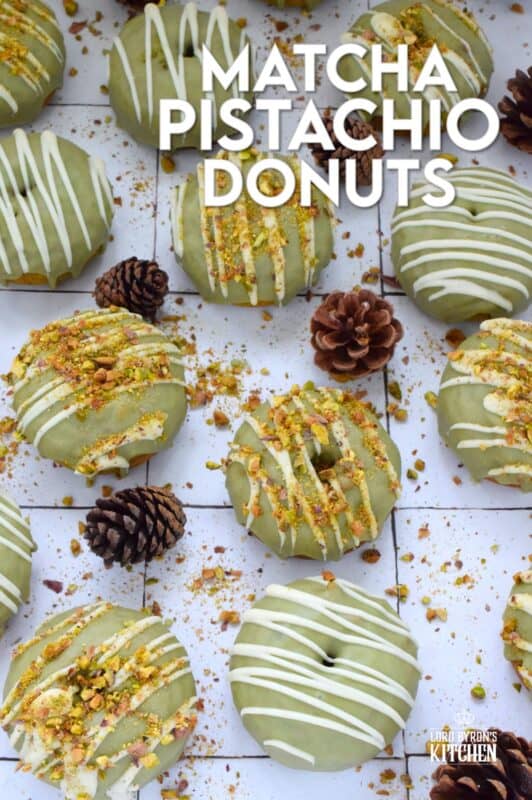 Everything is coming up green in these Matcha Pistachio Donuts! The batter is light and fluffy and prepared with finely chopped pistachios and matcha. Dipped in matcha-infused icing and drizzled with white chocolate, these donuts are delicious and addictive! #matcha #greentea #donuts #pistachio