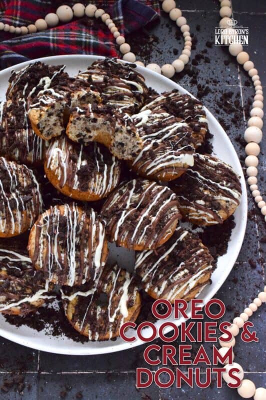 Crushed Oreo cookies are packed into the most delicious vanilla cake donuts and topped with smooth, melted white and milk chocolate, and even more crushed Oreos! Don't worry about the indulgence of these donuts because they're baked and not fried which means you're saving on calories! Right!? #cookiesandcream #oreo #donuts