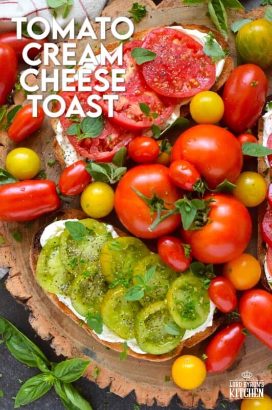 Summer fresh tomatoes are piled onto lightly toasted bread with a generous spread made with cream cheese. Tomato Cream Cheese Toast is a delicious summertime lunch or an appetizer too! Don't forget to season the tomatoes well and use fresh herbs for flavour and garnish. #sandwich #tomato #openfaced #creamcheese