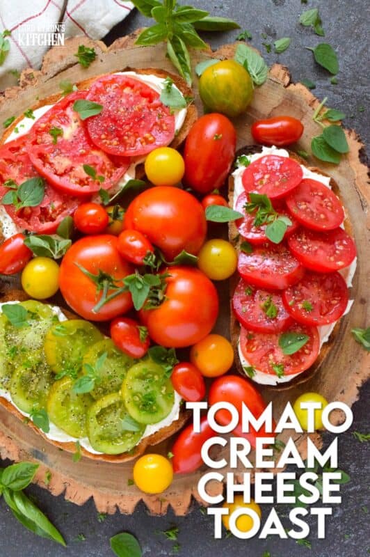 Summer fresh tomatoes are piled onto lightly toasted bread with a generous spread made with cream cheese. Tomato Cream Cheese Toast is a delicious summertime lunch or an appetizer too! Don't forget to season the tomatoes well and use fresh herbs for flavour and garnish. #sandwich #tomato #openfaced #creamcheese