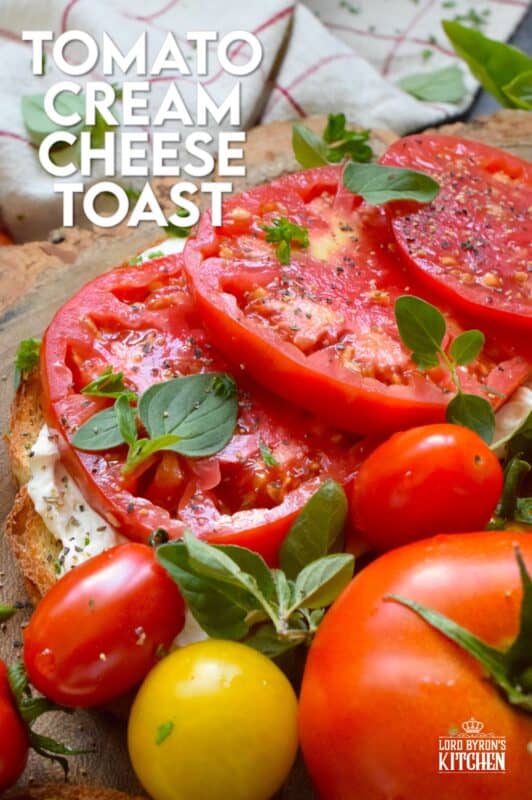 Summer fresh tomatoes are piled onto lightly toasted bread with a generous spread made with cream cheese. Tomato Cream Cheese Toast is a delicious summertime lunch or an appetizer too! Don't forget to season the tomatoes well and use fresh herbs for flavour and garnish. #sandwich #tomato #openfaced #creamcheese