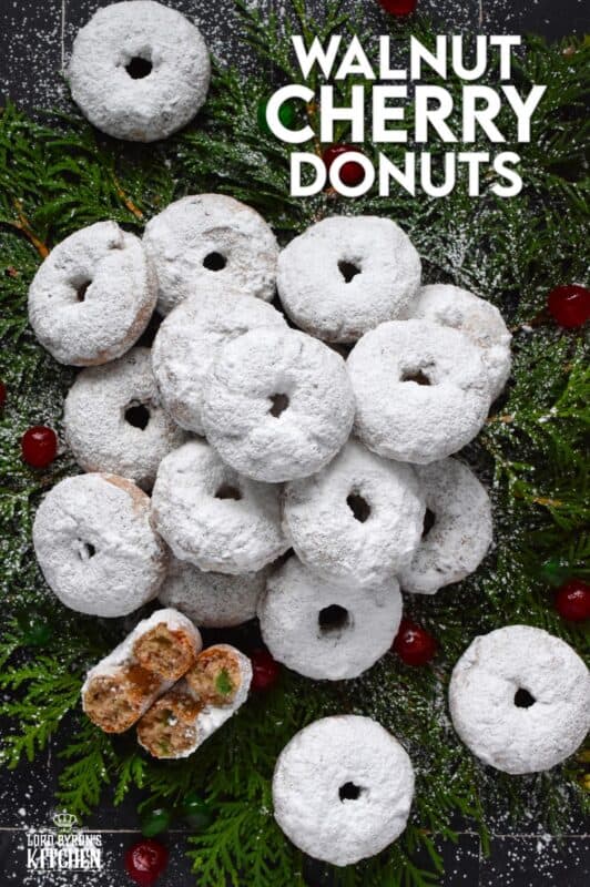 Packed full of red and green candied cherries and chopped toasted walnuts, these Walnut Cherry Donuts are the epitome of holiday-themed donuts! Baked with familiar Christmas spices, this donut is very similar in flavour to fruitcake - but without the fuss! #walnut #candied #cherries #donuts