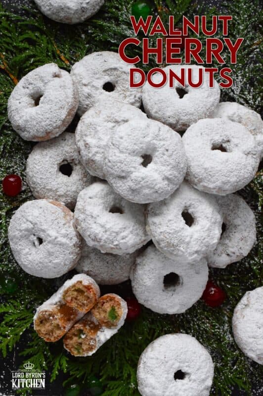 Packed full of red and green candied cherries and chopped toasted walnuts, these Walnut Cherry Donuts are the epitome of holiday-themed donuts! Baked with familiar Christmas spices, this donut is very similar in flavour to fruitcake - but without the fuss! #walnut #candied #cherries #donuts