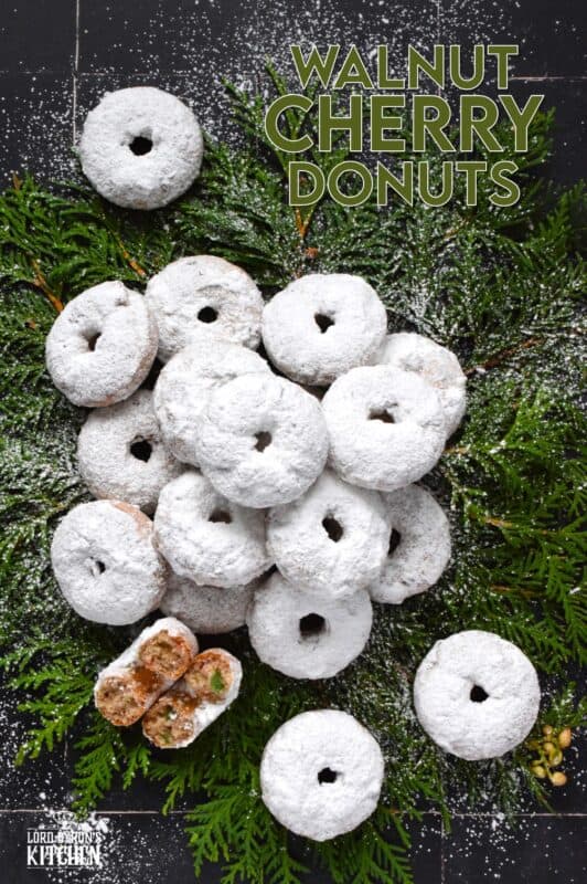 Packed full of red and green candied cherries and chopped toasted walnuts, these Walnut Cherry Donuts are the epitome of holiday-themed donuts! Baked with familiar Christmas spices, this donut is very similar in flavour to fruitcake - but without the fuss! #walnut #candied #cherries #donuts