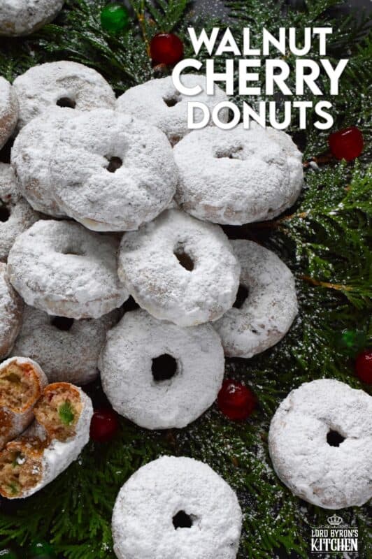 Packed full of red and green candied cherries and chopped toasted walnuts, these Walnut Cherry Donuts are the epitome of holiday-themed donuts! Baked with familiar Christmas spices, this donut is very similar in flavour to fruitcake - but without the fuss! #walnut #candied #cherries #donuts