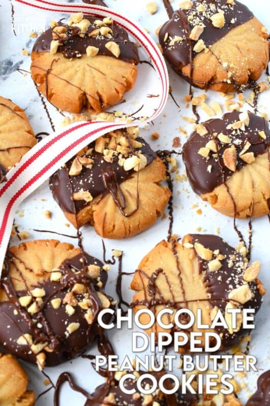 In our home, you cannot go wrong with the classic combination of peanut butter and chocolate! These delicious Chocolate Dipped Peanut Butter Cookies are dipped in melted chocolate and topped with a sprinkling of chopped salted peanuts. These are so easy to make, so whip up several batches and gift them to your friends, neighbours, and coworkers! #peanutbutter #cookies #chocolate #christmas #holiday #baking
