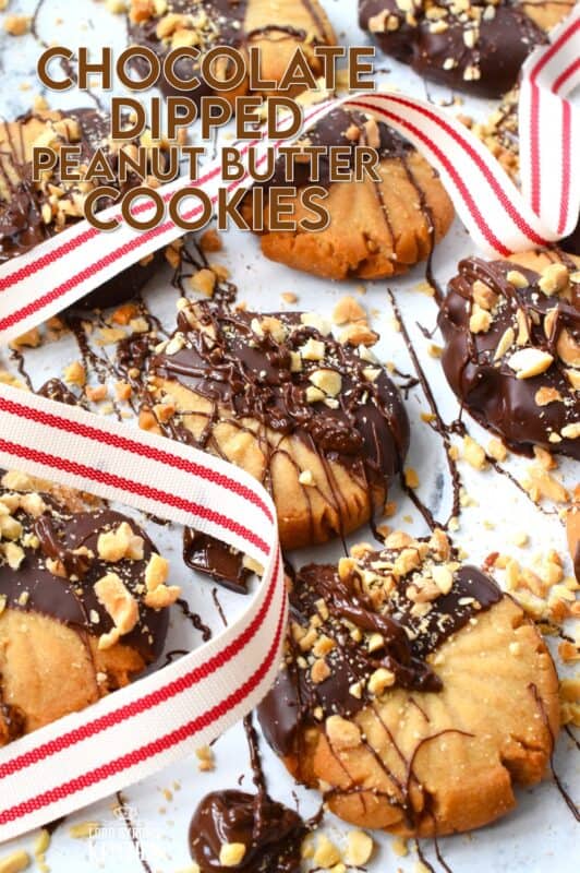 In our home, you cannot go wrong with the classic combination of peanut butter and chocolate! These delicious Chocolate Dipped Peanut Butter Cookies are dipped in melted chocolate and topped with a sprinkling of chopped salted peanuts. These are so easy to make, so whip up several batches and gift them to your friends, neighbours, and coworkers! #peanutbutter #cookies #chocolate #christmas #holiday #baking