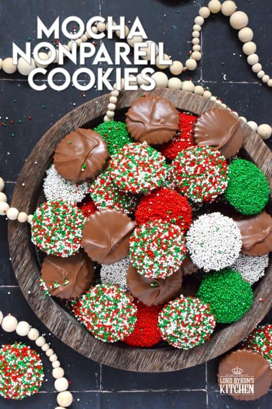Prepared with good baking cocoa, these Mocha Nonpareil Cookies are dipped in melted milk chocolate and covered with everyone's favourite sprinkles! The cookies are firm and crisp, but they melt in your mouth. Baked with a splash of coffee extract, everyone will be trying to guess why these cookies taste so good! #nonpareil #sprinkles #cookies #christmas #chocoalte #dipped