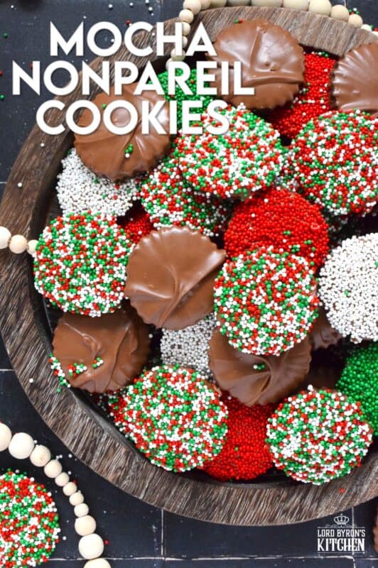 Prepared with good baking cocoa, these Mocha Nonpareil Cookies are dipped in melted milk chocolate and covered with everyone's favourite sprinkles! The cookies are firm and crisp, but they melt in your mouth. Baked with a splash of coffee extract, everyone will be trying to guess why these cookies taste so good! #nonpareil #sprinkles #cookies #christmas #chocoalte #dipped