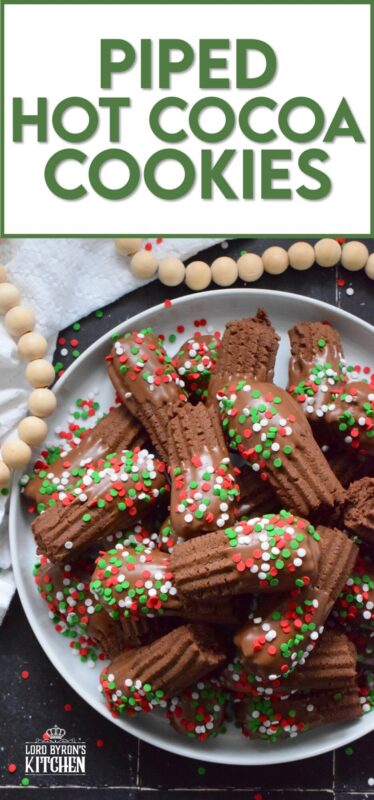 Buttery and chocolatey, Piped Hot Cocoa Cookies are delicious just as they are, but they're even better dipped in silky smooth melted milk chocolate! Not only are these fun to make, but everyone loves them! Be sure to include these tasty little treats on your holiday dessert table this year! #chocolate #cocoa #hotcocoa #cookies