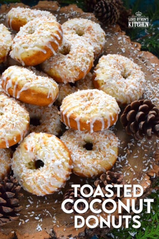 In our home, Christmas would not be Christmas without a confection prepared with coconut and these Toasted Coconut Donuts hit the mark! These are baked and not fried so they are super light! Imagine an old-fashioned glazed donut but with the addition of nutty, crispy toasted coconut - yum! #toasted #coconut #donuts