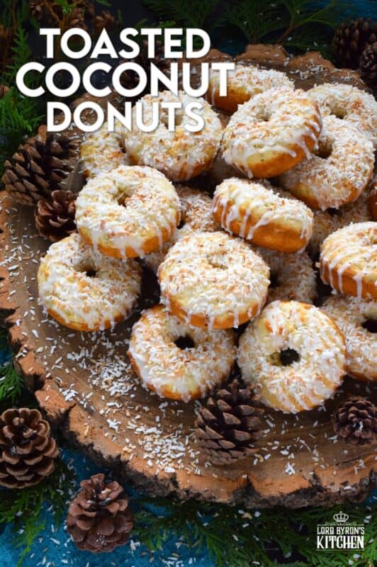 In our home, Christmas would not be Christmas without a confection prepared with coconut and these Toasted Coconut Donuts hit the mark! These are baked and not fried so they are super light! Imagine an old-fashioned glazed donut but with the addition of nutty, crispy toasted coconut - yum! #toasted #coconut #donuts
