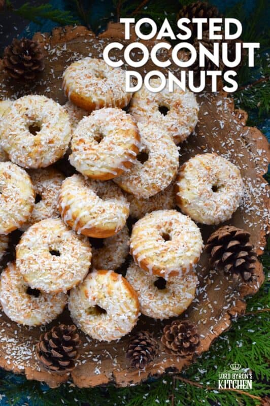 In our home, Christmas would not be Christmas without a confection prepared with coconut and these Toasted Coconut Donuts hit the mark! These are baked and not fried so they are super light! Imagine an old-fashioned glazed donut but with the addition of nutty, crispy toasted coconut - yum! #toasted #coconut #donuts
