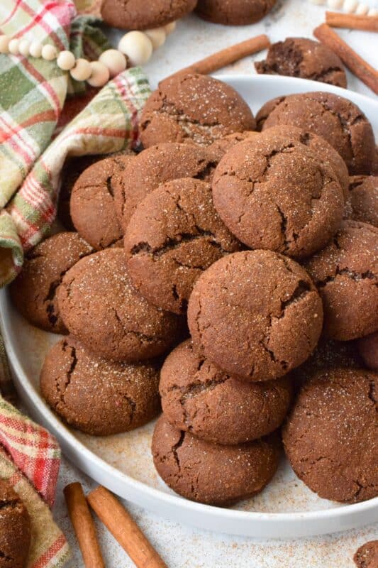 Everyone loves the original snickerdoodle cookie, but this chocolate version is even more delicious!  Prepared with brown sugar and cocoa, the cookies are rolled in a cinnamon sugar mixture, which gives the cookie that recognizable and familiar crinkly appearance.  Chocolate Snickerdoodle Cookies are soft and chewy with slightly crispy outer edges. #snickerdoodles #christmas #cookies #cinnamon