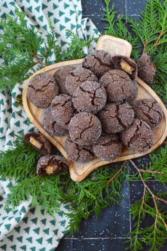 These cookies were prepared with the ultimate chocolate and peanut butter lover in mind. Reese's Peanut Butter Cup Stuffed Cookies are prepared with a rich chocolaty and fudgy base, which is wrapped around a single miniature peanut butter cup candy. These are perfect for Christmastime when calories don't count! #reeses #peanutbuttercups #stuffed #cookies