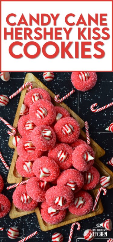 A deliciously decadent peppermint cookie, coated in sugar, and topped with a Hershey's white chocolate kiss, Candy Cane Hershey Kiss Cookies are a perfect holiday treat that everyone will love! These are quick and easy – no need to chill the cookie dough before baking either! Don't they look absolutely adorable!? #thumbprint #hershey #kisses #candycane
