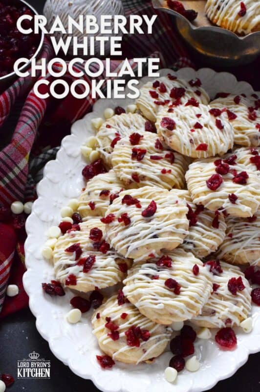 Cranberry White Chocolate Cookies are a simplified version of the seasonally popular bliss bar at Starbucks. Prepared with a light sugar cookie base which is packed with dried cranberries and white chocolate chips, these cookies are topped with a drizzle of white chocolate and even more dried cranberries. #cranberry #chocolate #cookies