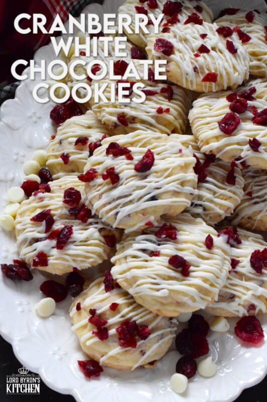 Cranberry White Chocolate Cookies are a simplified version of the seasonally popular bliss bar at Starbucks. Prepared with a light sugar cookie base which is packed with dried cranberries and white chocolate chips, these cookies are topped with a drizzle of white chocolate and even more dried cranberries. #cranberry #chocolate #cookies