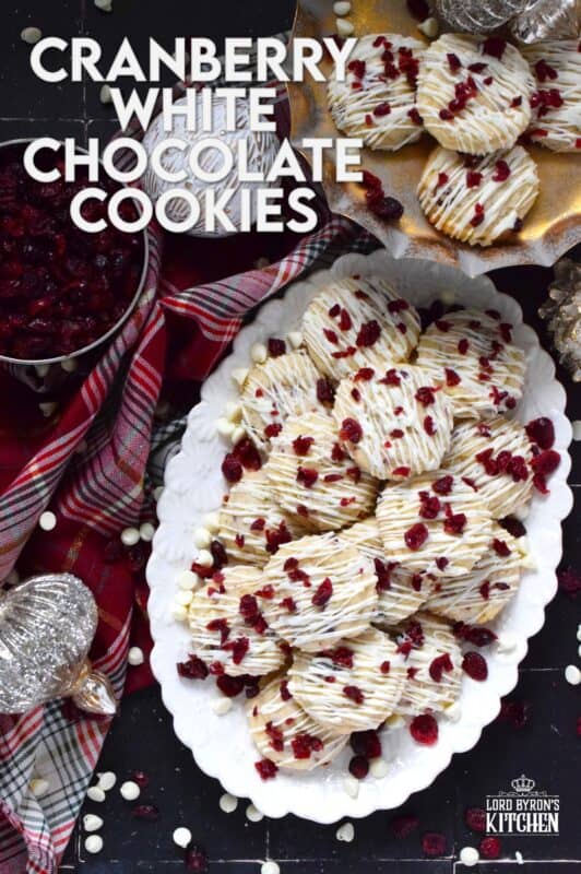 Cranberry White Chocolate Cookies are a simplified version of the seasonally popular bliss bar at Starbucks. Prepared with a light sugar cookie base which is packed with dried cranberries and white chocolate chips, these cookies are topped with a drizzle of white chocolate and even more dried cranberries. #cranberry #chocolate #cookies