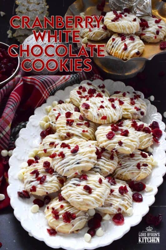 Cranberry White Chocolate Cookies are a simplified version of the seasonally popular bliss bar at Starbucks. Prepared with a light sugar cookie base which is packed with dried cranberries and white chocolate chips, these cookies are topped with a drizzle of white chocolate and even more dried cranberries. #cranberry #chocolate #cookies